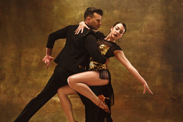 dance-ballroom-couple-in-gold-dress-dancing-on-studio.jpg